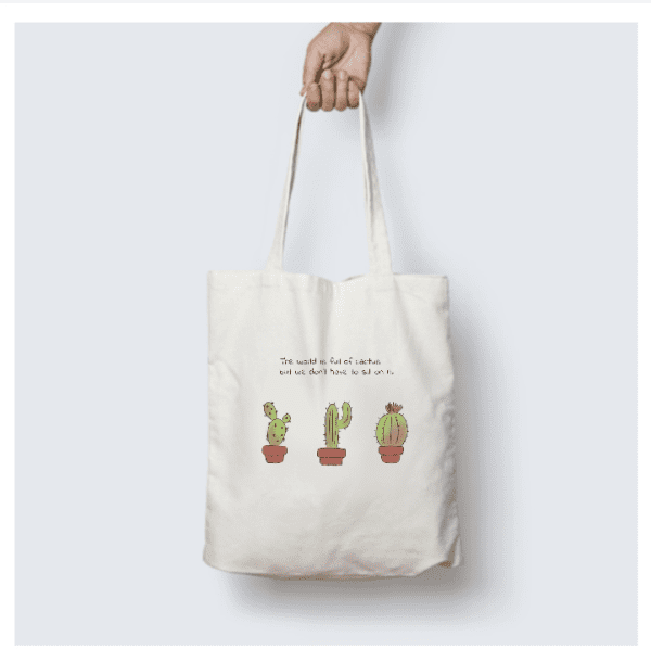 Natural cotton tote bag with cactus illustration and inspirational quote, perfect for eco-friendly fashion.
